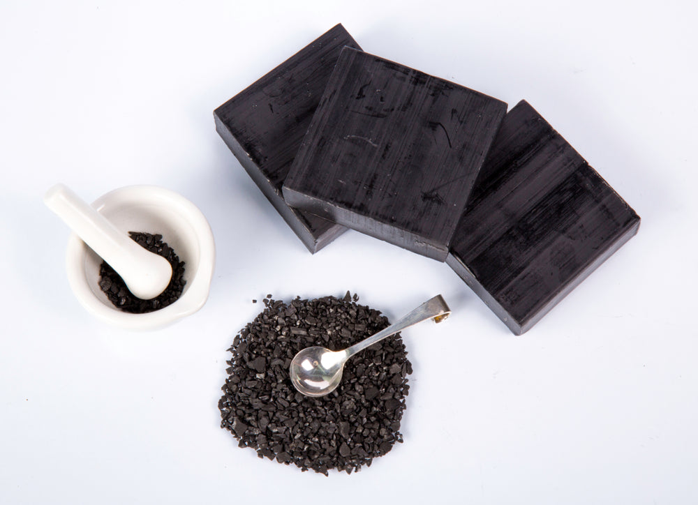 Three square black soaps made with activated charcoal and all natural ingredients. Handcrafted soap made with olive oil, coconut oil, organic shea butter for soft and nourished skin. Runoku all natural bath and body Kylo soap